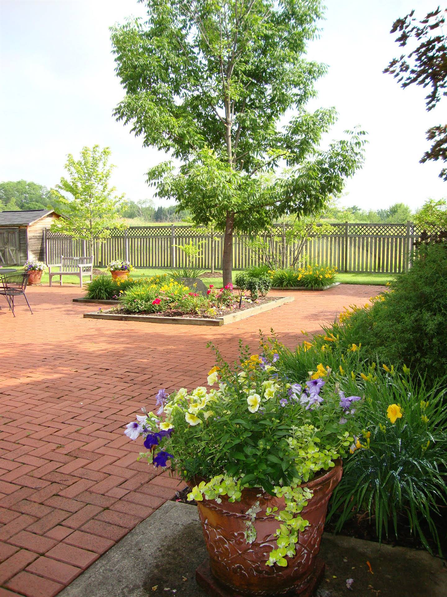 Trees and flowers on brick patio at Orange Senior Center