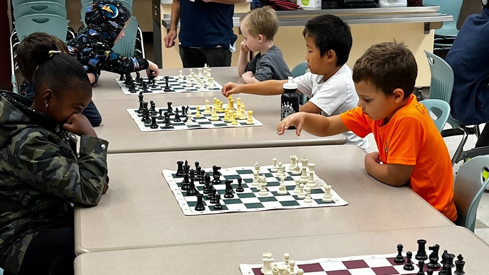 Six children playing chess