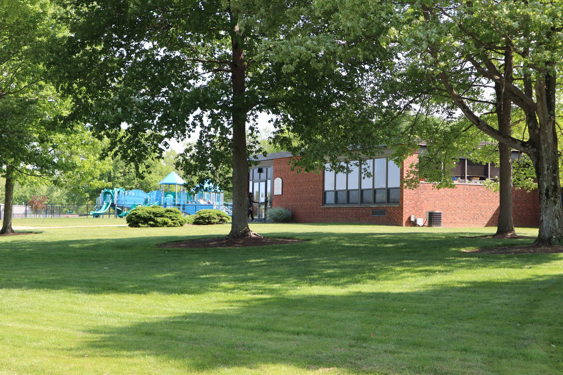Picture of the outside of Pepper Pike Learning Center with playground in the background